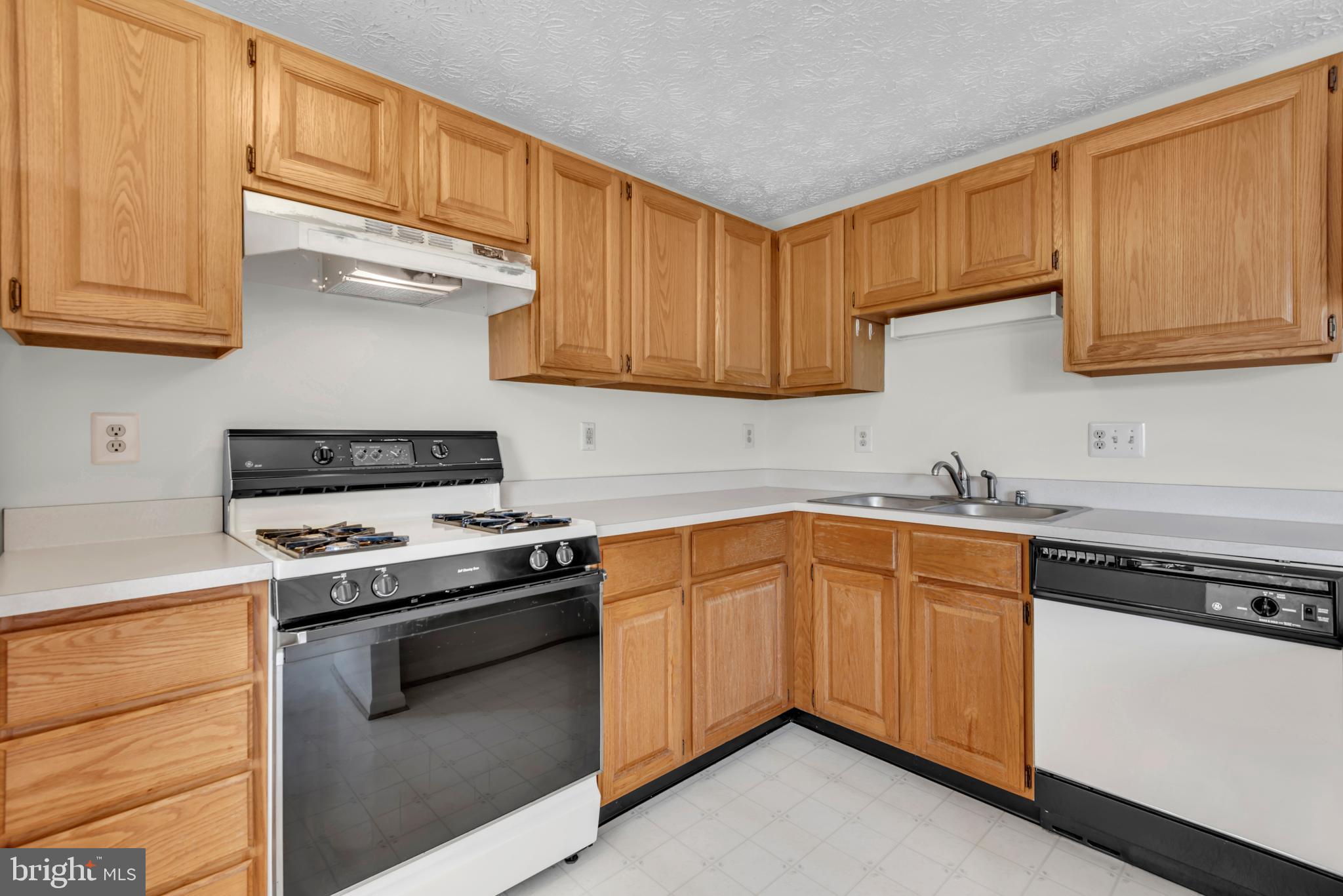 2407 Warm Spring Way Odenton, MD 21113 - Photo 9 of 45 a kitchen with stainless steel appliances granite countertop a stove and a sink