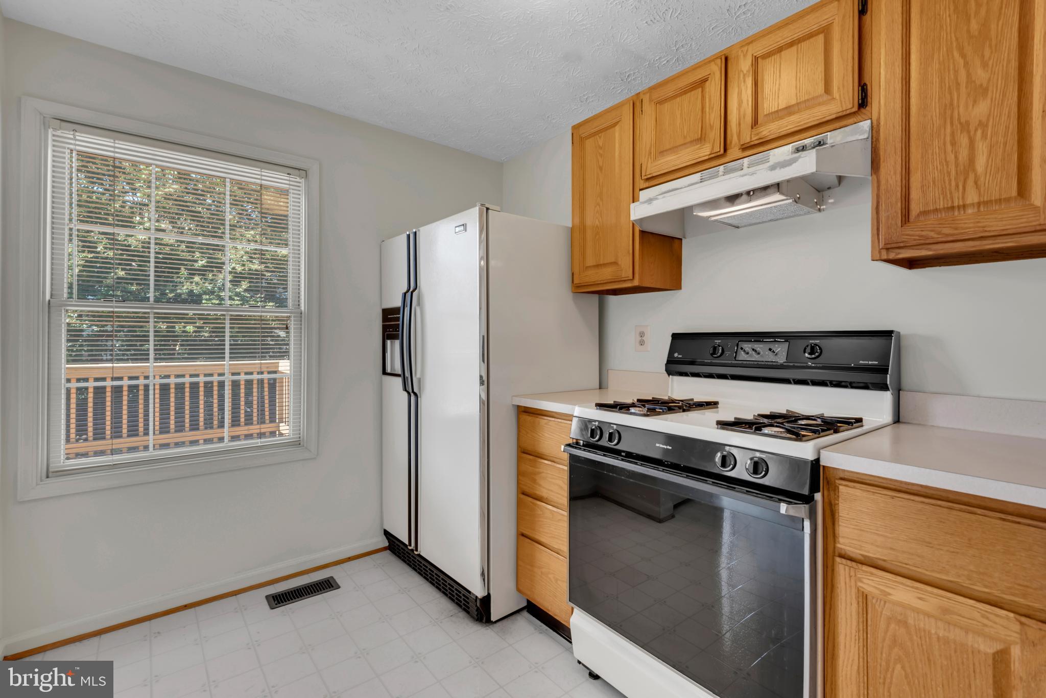 2407 Warm Spring Way Odenton, MD 21113 - Photo 10 of 45 a kitchen with stainless steel appliances granite countertop a stove and a refrigerator