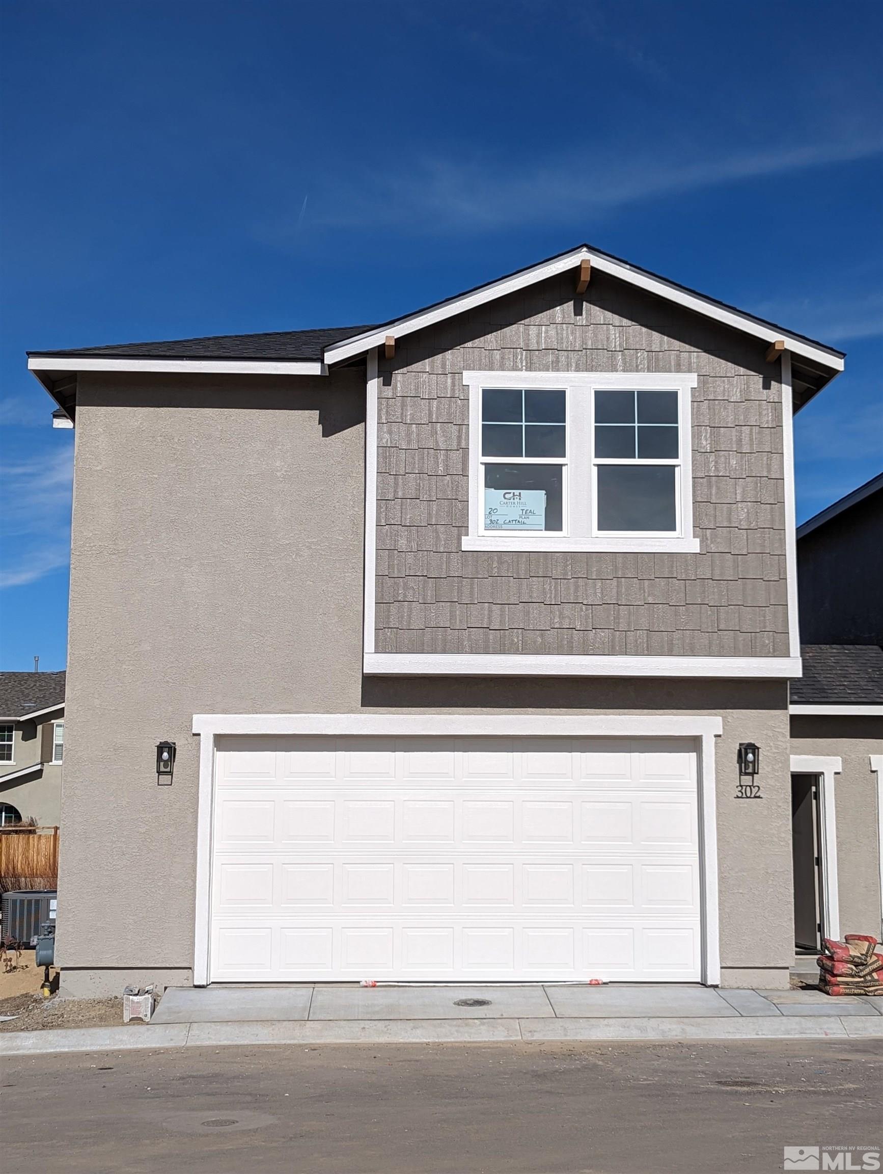 302 Cattail Circle, Unit 20 Gardnerville, NV 89410 - Photo 2 of 5 a view of a house with a garage