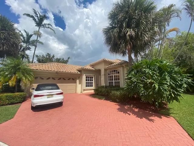 a car parked in front of a house with a yard