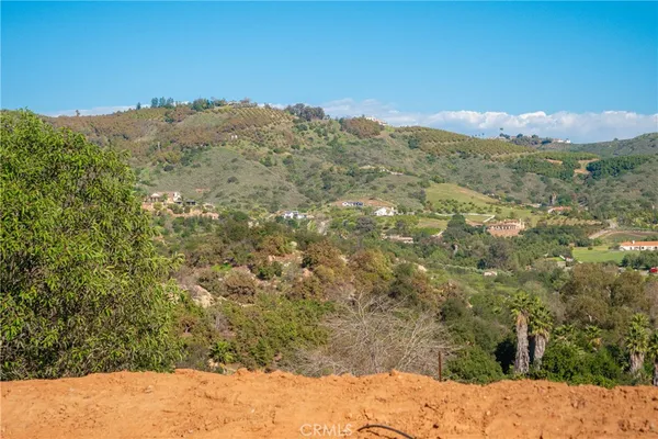 a view of a large building with mountains in the background