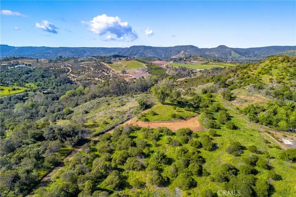 a view of a field with mountains in the background