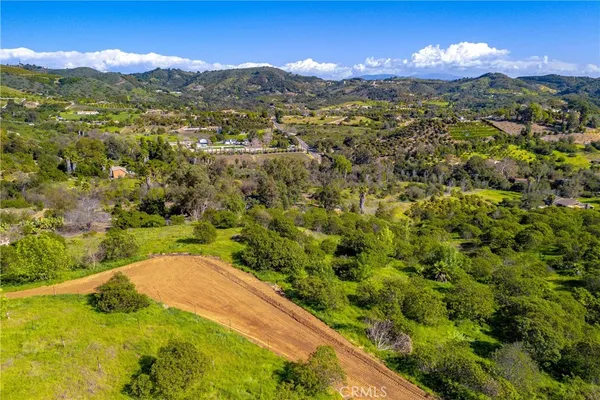 a view of a houses with a lush green hillside