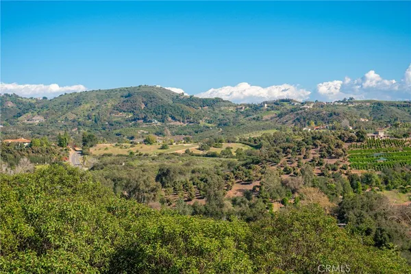 a view of a lush green hillside and a building