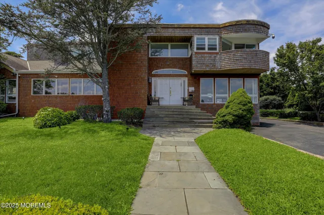 an aerial view of a house with garden space and street view