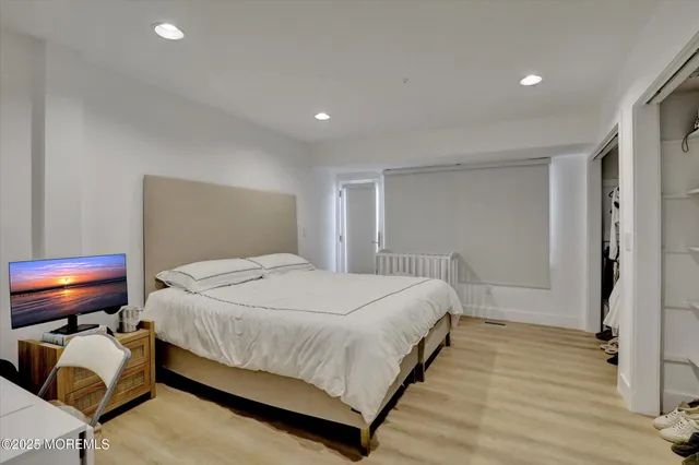 a bathroom with a granite countertop sink mirror vanity and toilet