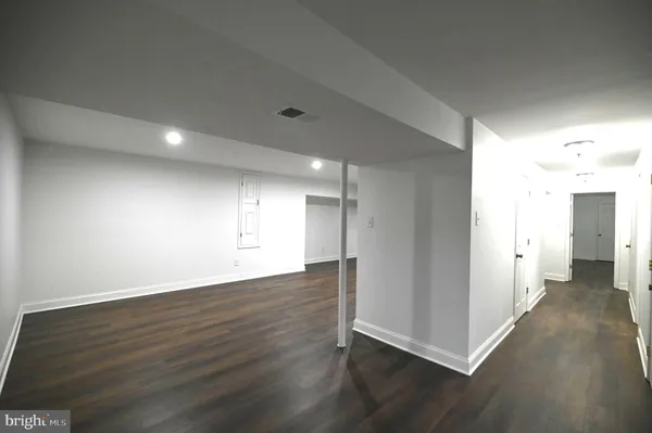 a view of wooden floor and windows in a room
