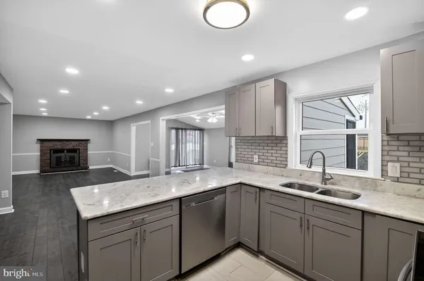 an empty room with wooden floor and fireplace