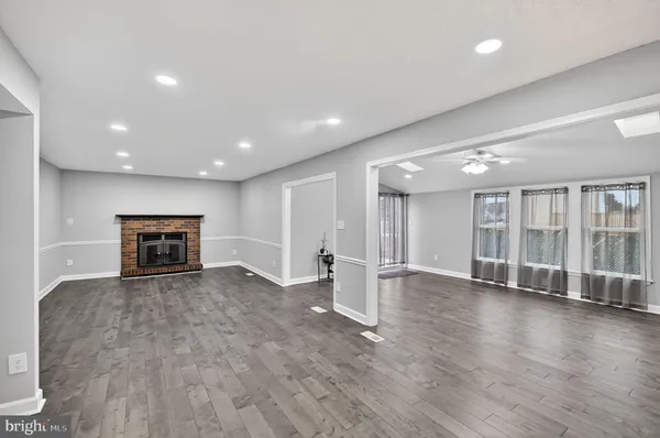 a view of a kitchen with wooden floor and electronic appliances