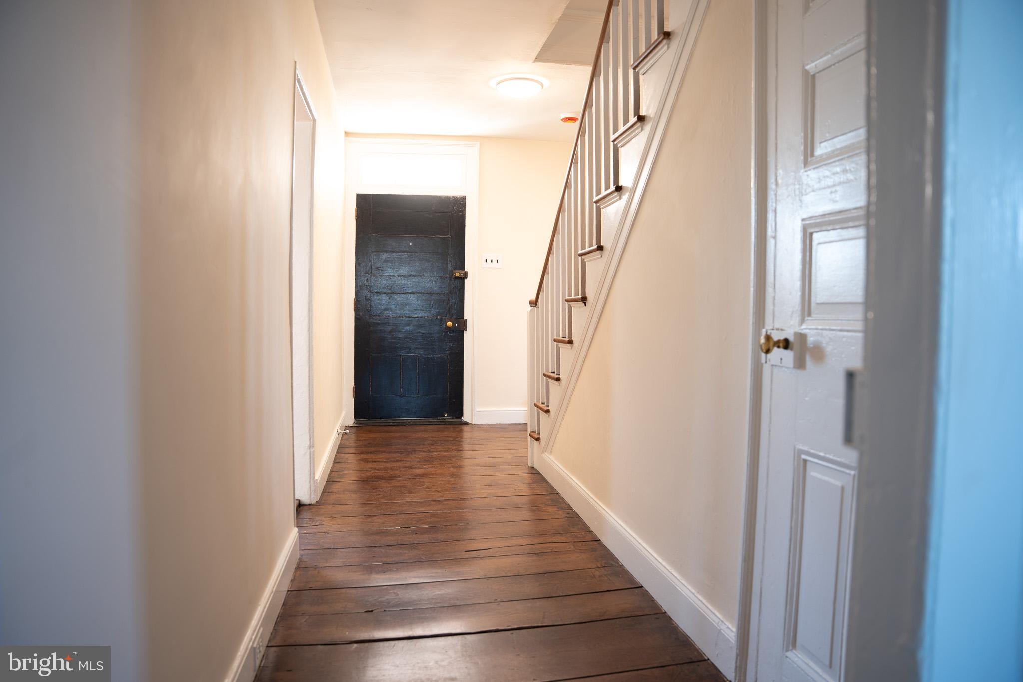 395 Bishop Hollow Road, Unit C Newtown Square, PA 19073 - Photo 15 of 28 a view of a hallway with wooden floor and staircase
