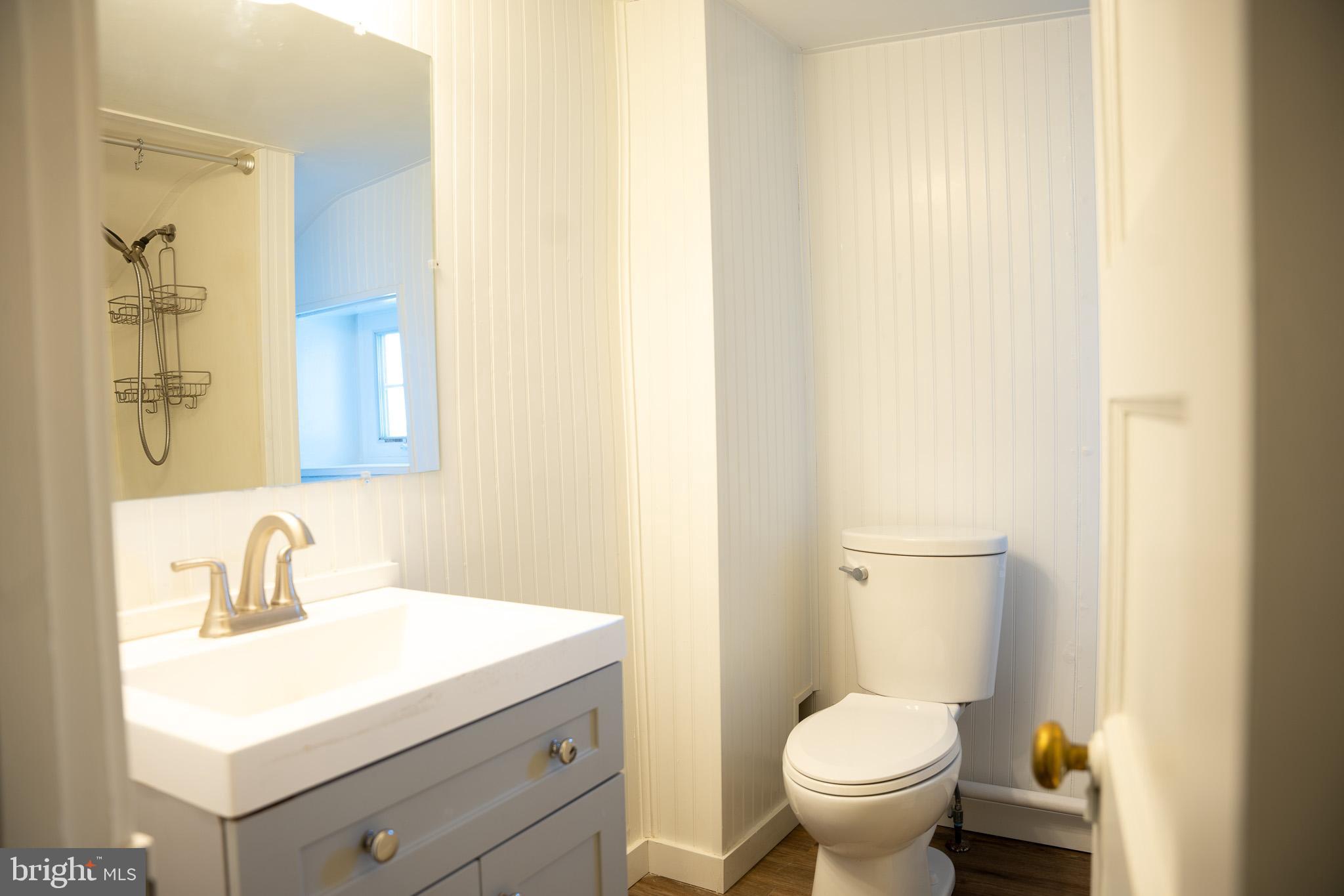 395 Bishop Hollow Road, Unit C Newtown Square, PA 19073 - Photo 23 of 28 a bathroom with a sink toilet and a mirror