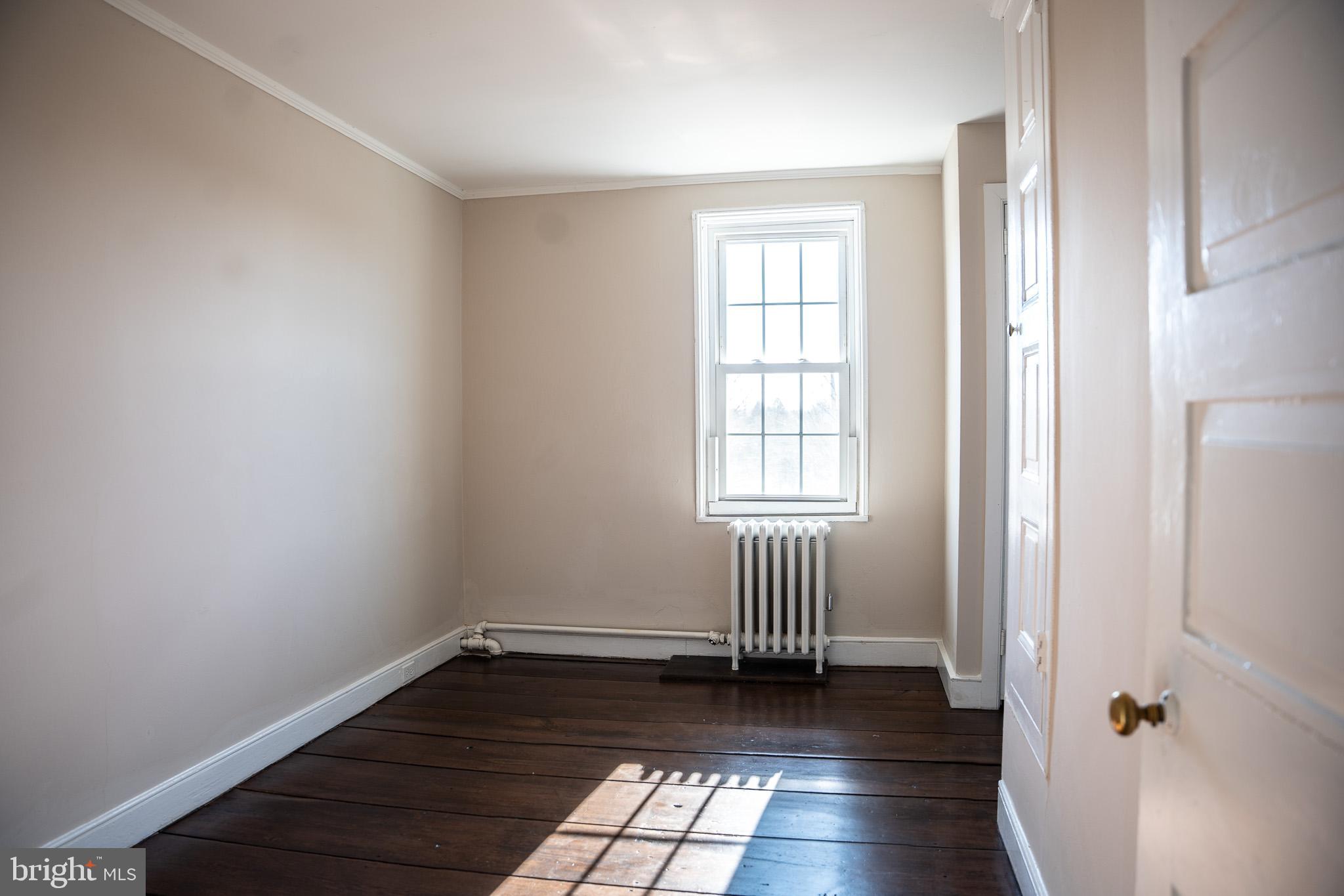 395 Bishop Hollow Road, Unit C Newtown Square, PA 19073 - Photo 24 of 28 an empty room with wooden floor and windows