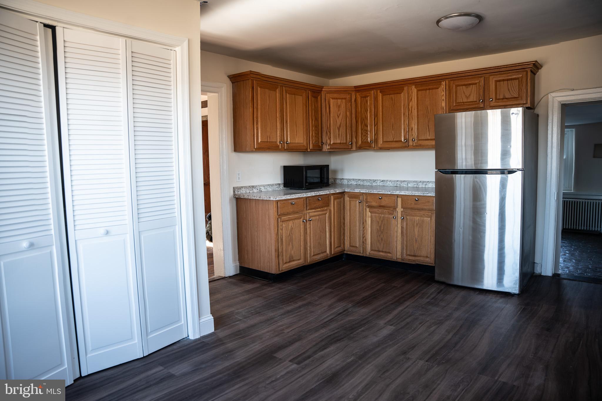395 Bishop Hollow Road, Unit C Newtown Square, PA 19073 - Photo 10 of 28 a kitchen with stainless steel appliances a refrigerator and wooden floor