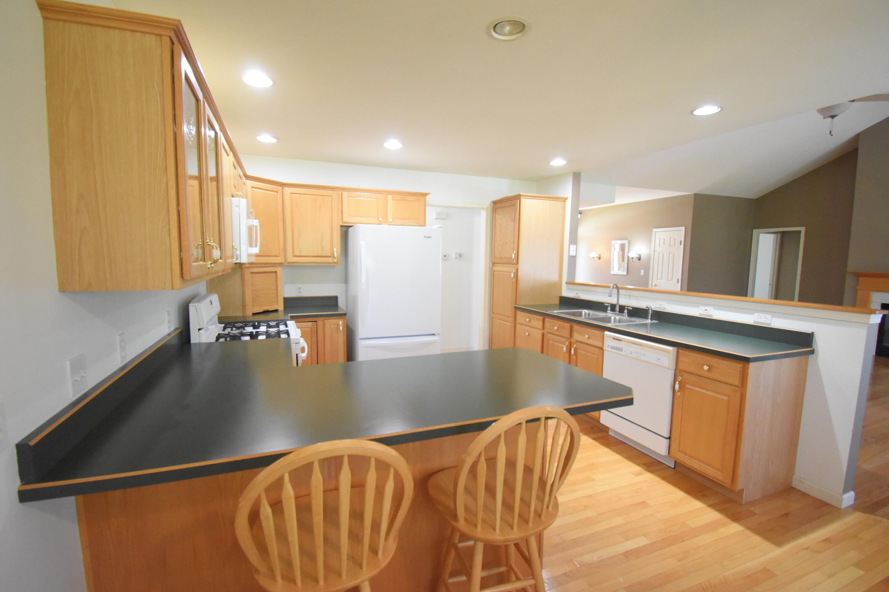 522 Pheasant Run Rensselaer, IN 47978 - Photo 27 of 55 a view of a kitchen with kitchen island a large window a sink and stainless steel appliances