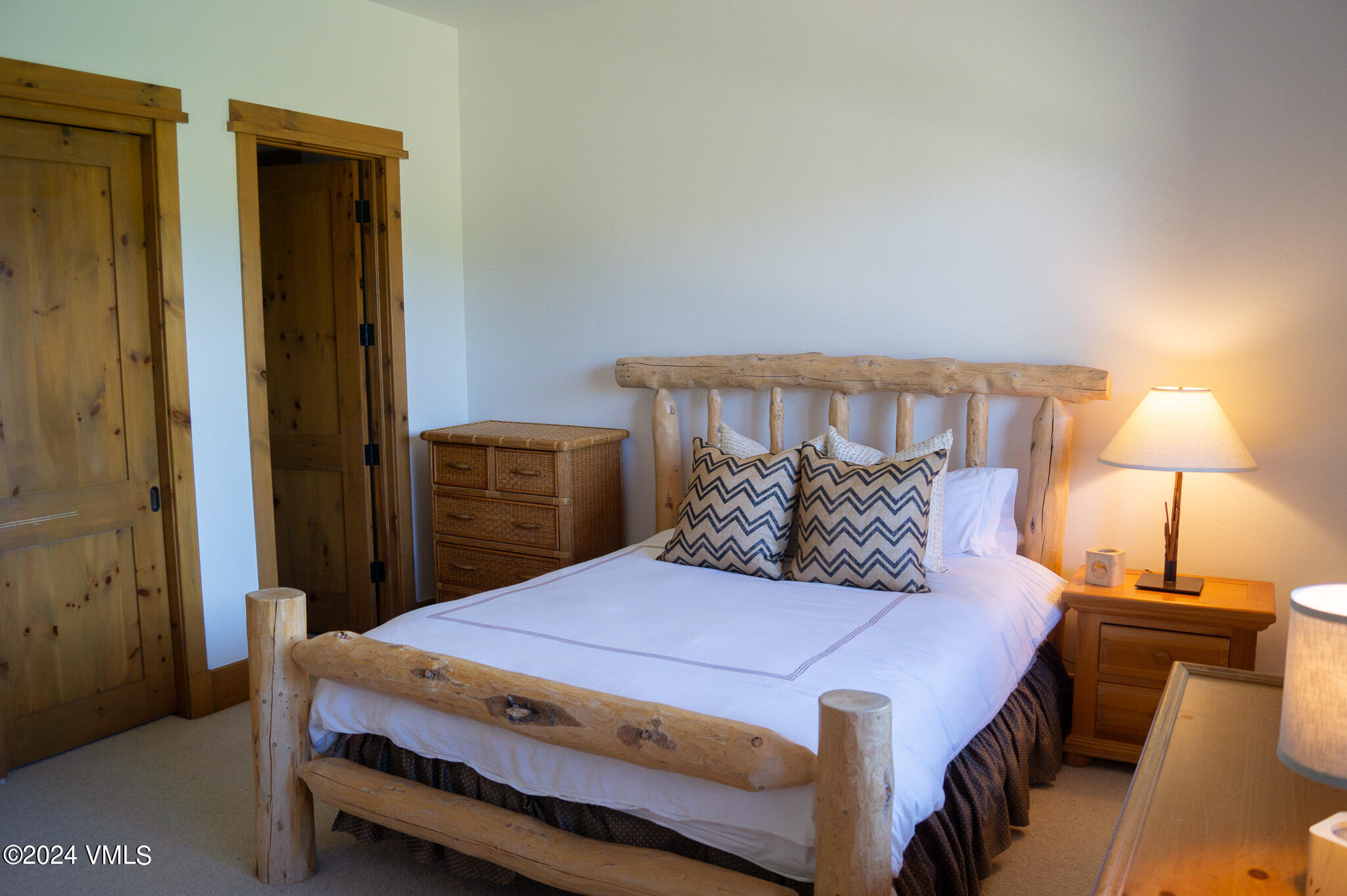 321 Legends Drive Edwards, CO 81632 - Photo 26 of 47 a bedroom with a bed and a lamp with the dresser