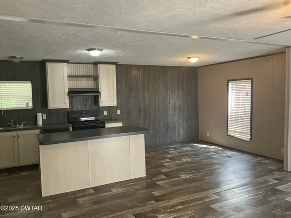 a kitchen with stainless steel appliances granite countertop a sink and a stove