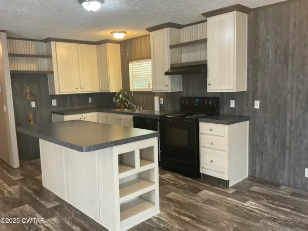 a kitchen with a stove a sink and a refrigerator