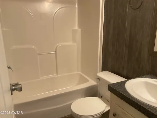 a bathroom with a toilet and a bath tub