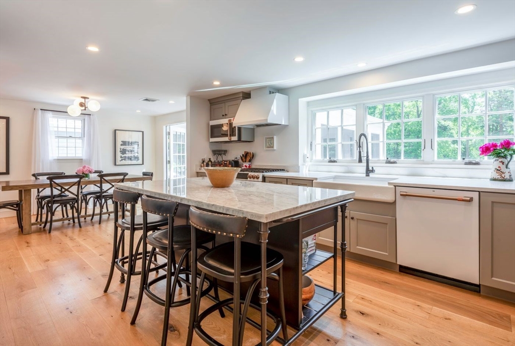 3 Jeffrey's Neck Road Ipswich, MA 01938 - Photo 13 of 42 a kitchen with a table chairs sink and cabinets