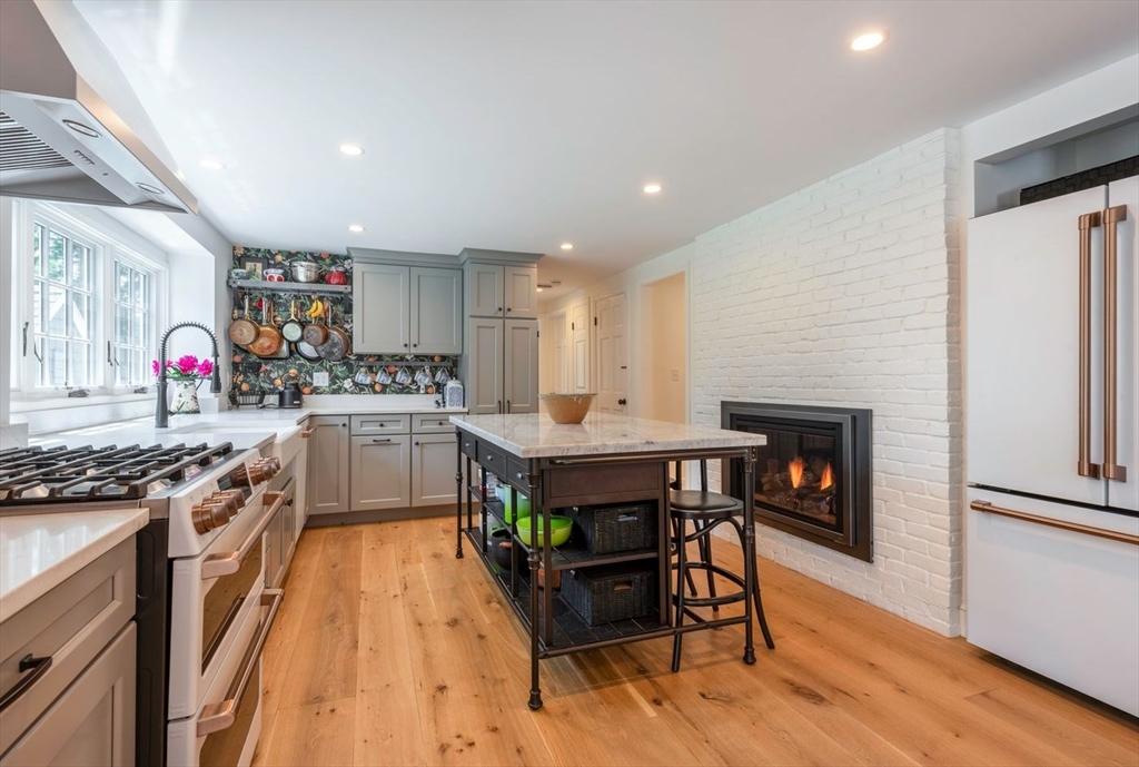 3 Jeffrey's Neck Road Ipswich, MA 01938 - Photo 15 of 42 a kitchen with a stove a refrigerator and a wooden cabinets