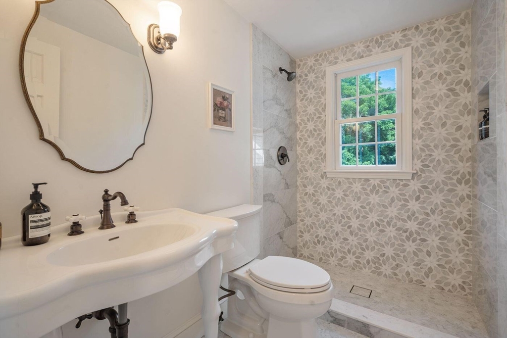 3 Jeffrey's Neck Road Ipswich, MA 01938 - Photo 23 of 42 a bathroom with a sink a toilet and a mirror