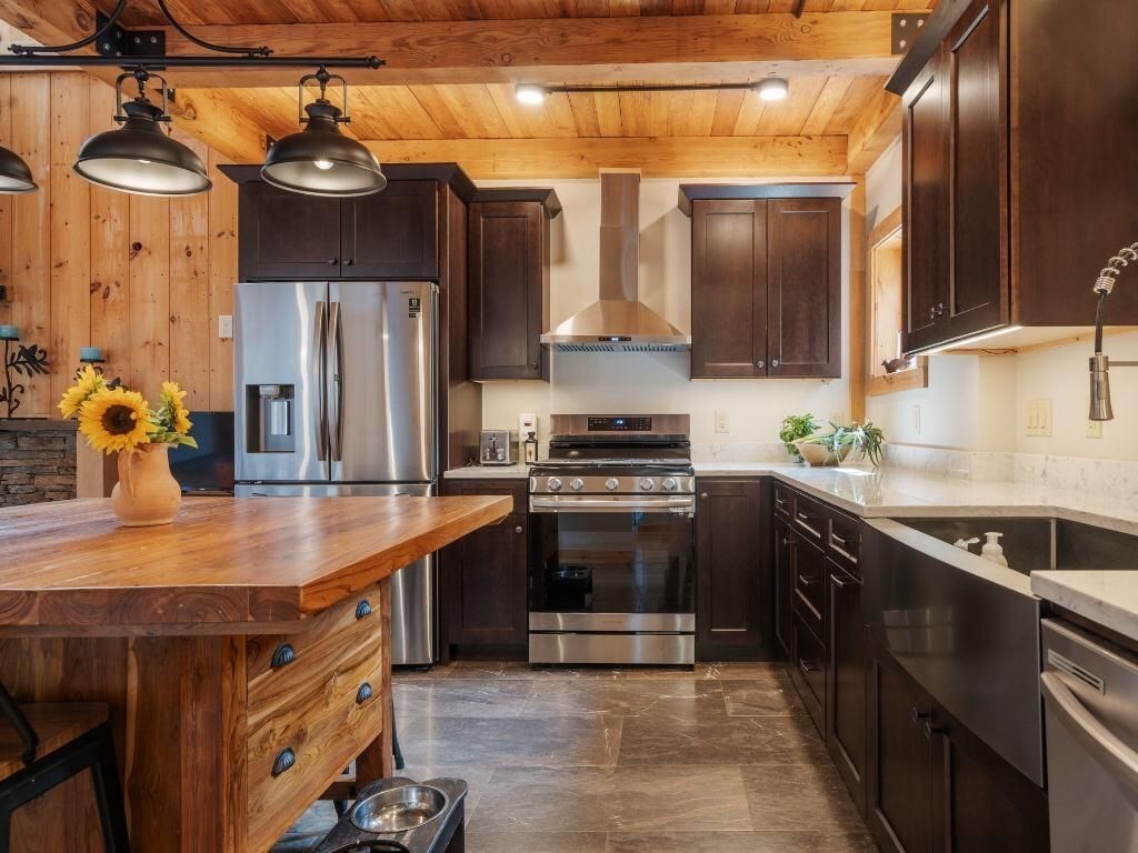 3 Jeffrey's Neck Road Ipswich, MA 01938 - Photo 39 of 42 a kitchen with stainless steel appliances granite countertop a sink and a stove