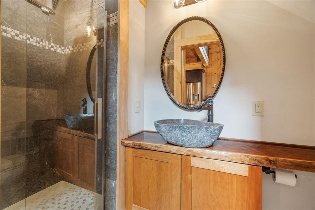 3 Jeffrey's Neck Road Ipswich, MA 01938 - Photo 42 of 42 a room with a mirror and vanity