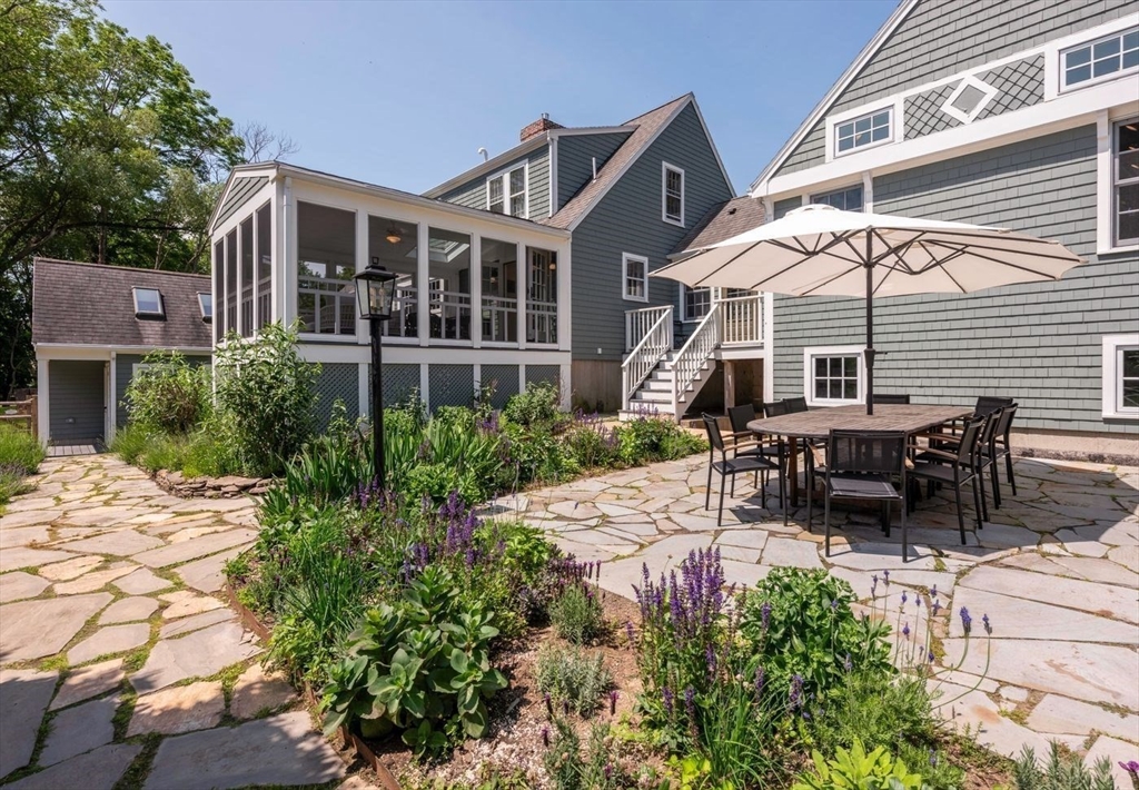 3 Jeffrey's Neck Road Ipswich, MA 01938 - Photo 7 of 42 a view of a patio with table and chairs under an umbrella