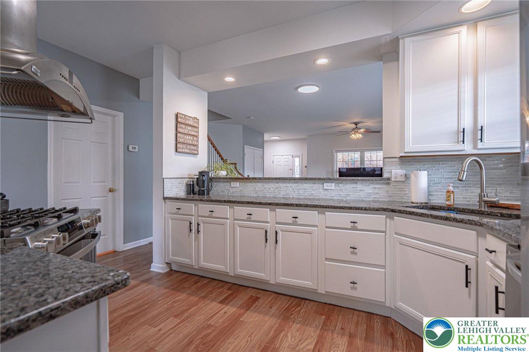 231 7th Avenue Bethlehem, PA 18018 - Photo 12 of 34 a kitchen with granite countertop white cabinets and white appliances