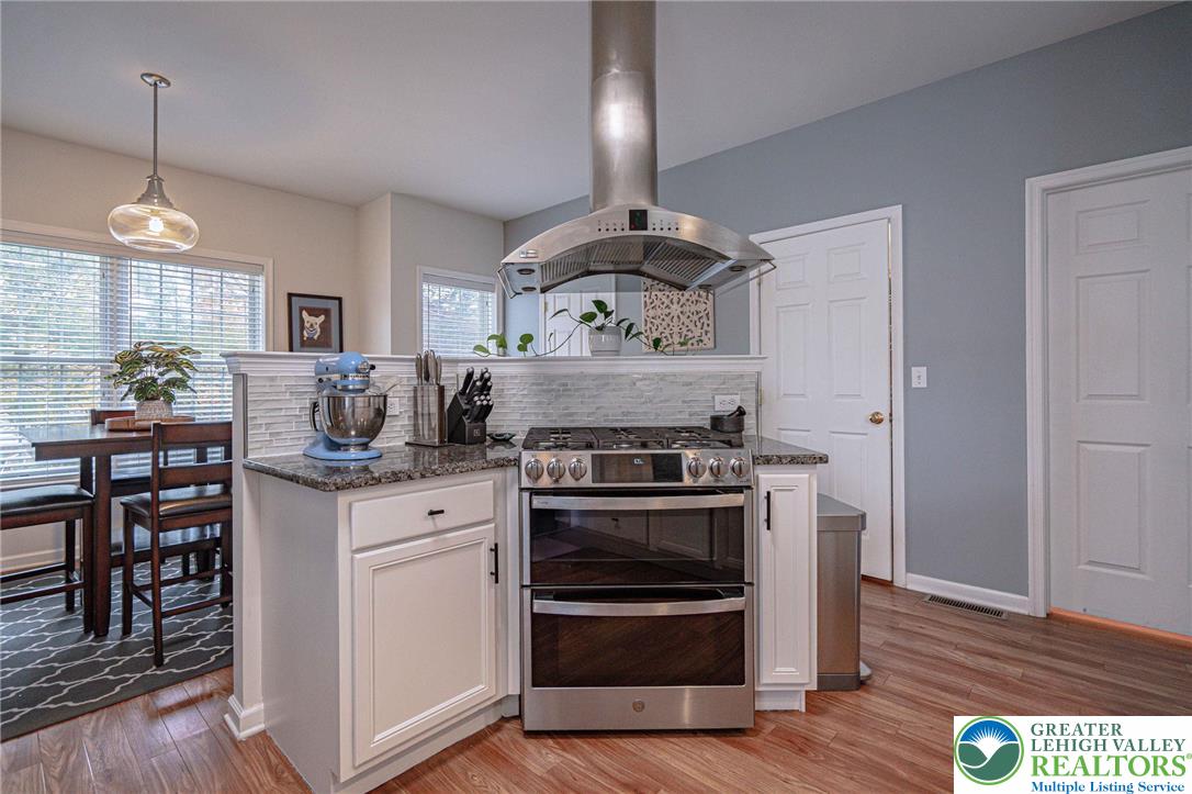 231 7th Avenue Bethlehem, PA 18018 - Photo 13 of 34 a kitchen with stainless steel appliances granite countertop a stove and a wooden floors