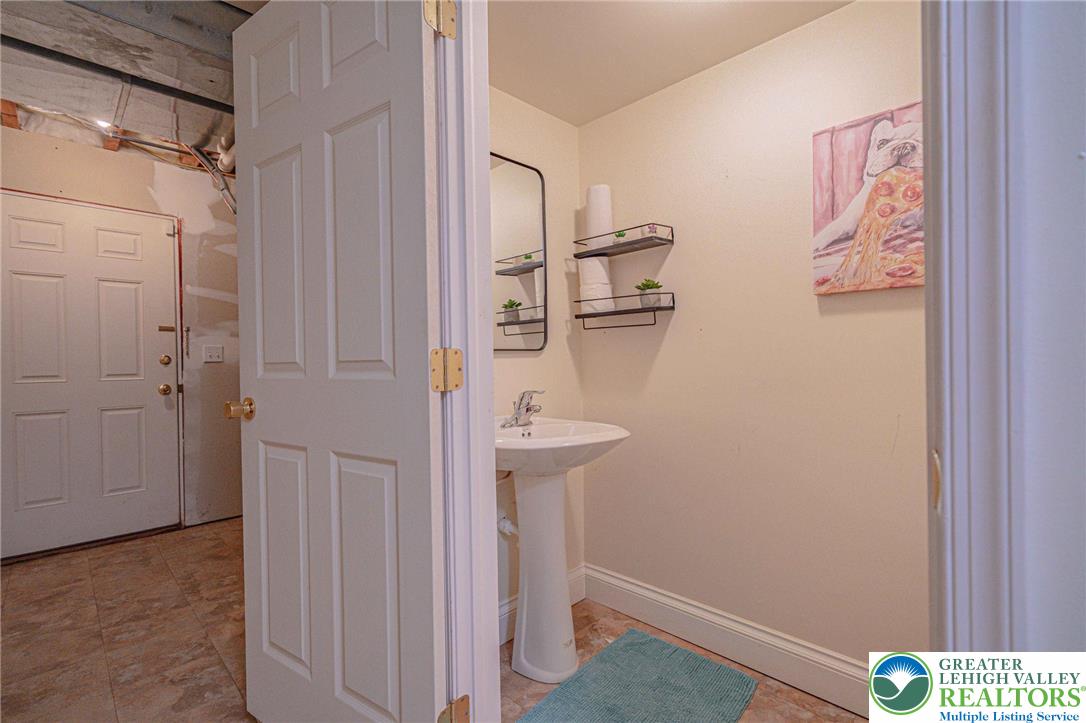 231 7th Avenue Bethlehem, PA 18018 - Photo 32 of 34 a bathroom with a sink and mirror