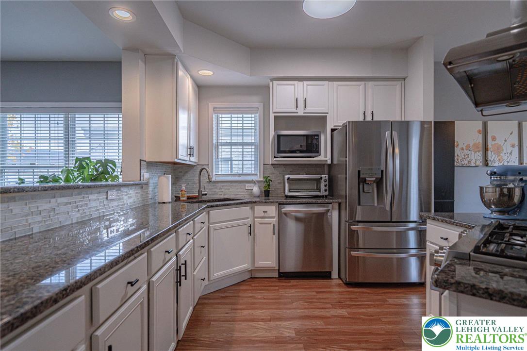 231 7th Avenue Bethlehem, PA 18018 - Photo 10 of 34 a kitchen with stainless steel appliances granite countertop a refrigerator stove and sink