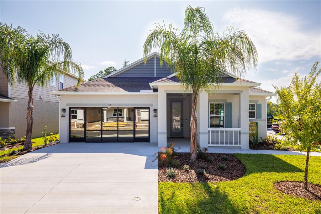 32 Enclave Avenue Palm Coast, FL 32164 - Photo 1 of 1 a front view of a house with garden