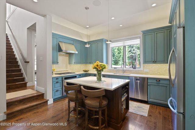 a dining room with a sink and chairs