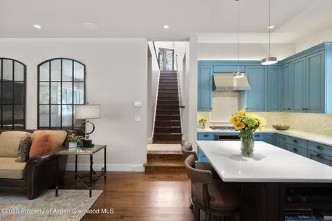 a dining room with furniture and wooden floor