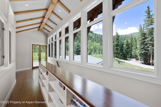a kitchen with large windows and a table