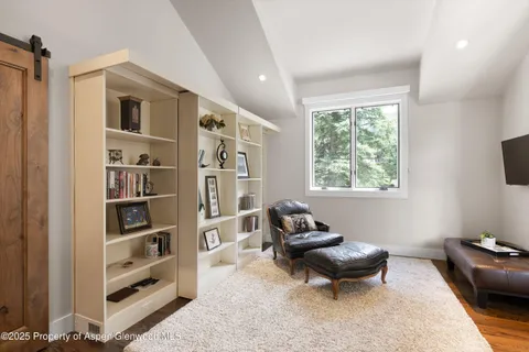 a living room with furniture cabinets and a window