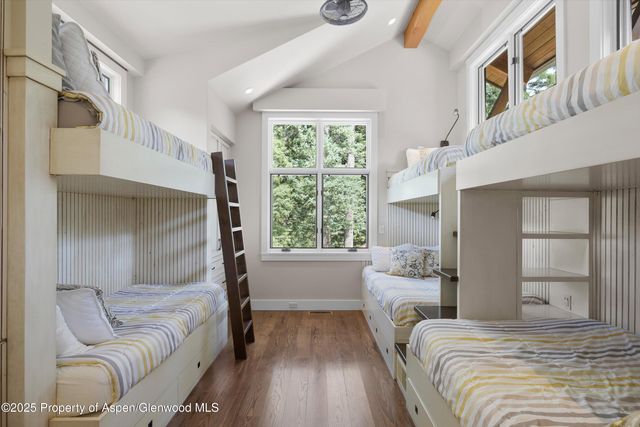 a bedroom with furniture and a large window