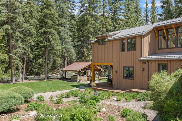 a view of a house with yard and sitting area