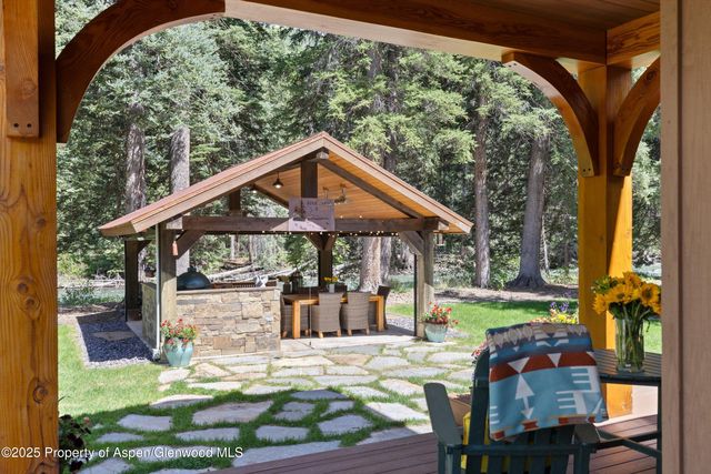 a front view of a house with a yard table and chairs