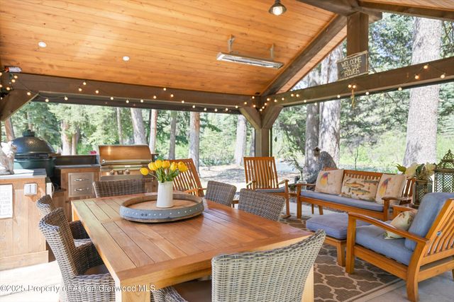 a dining room with furniture a large window and a table
