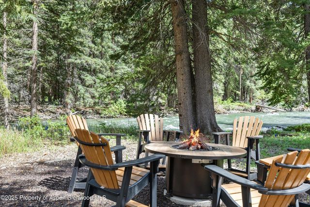 a view of backyard with table and chairs and couches