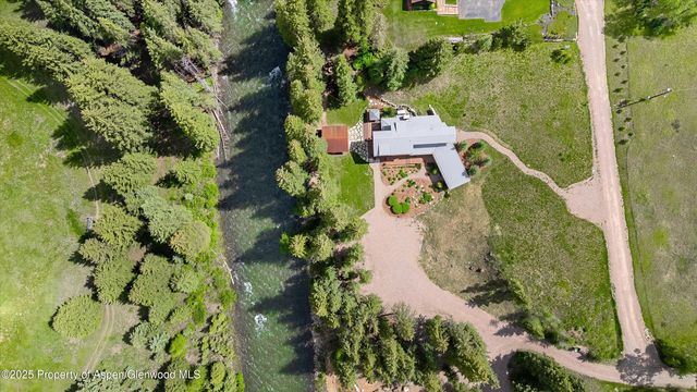 an aerial view of a house with a yard