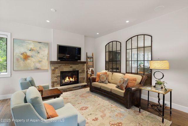 a living room with furniture fireplace and a flat screen tv