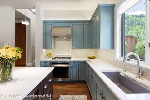 a kitchen with a sink stove and cabinets