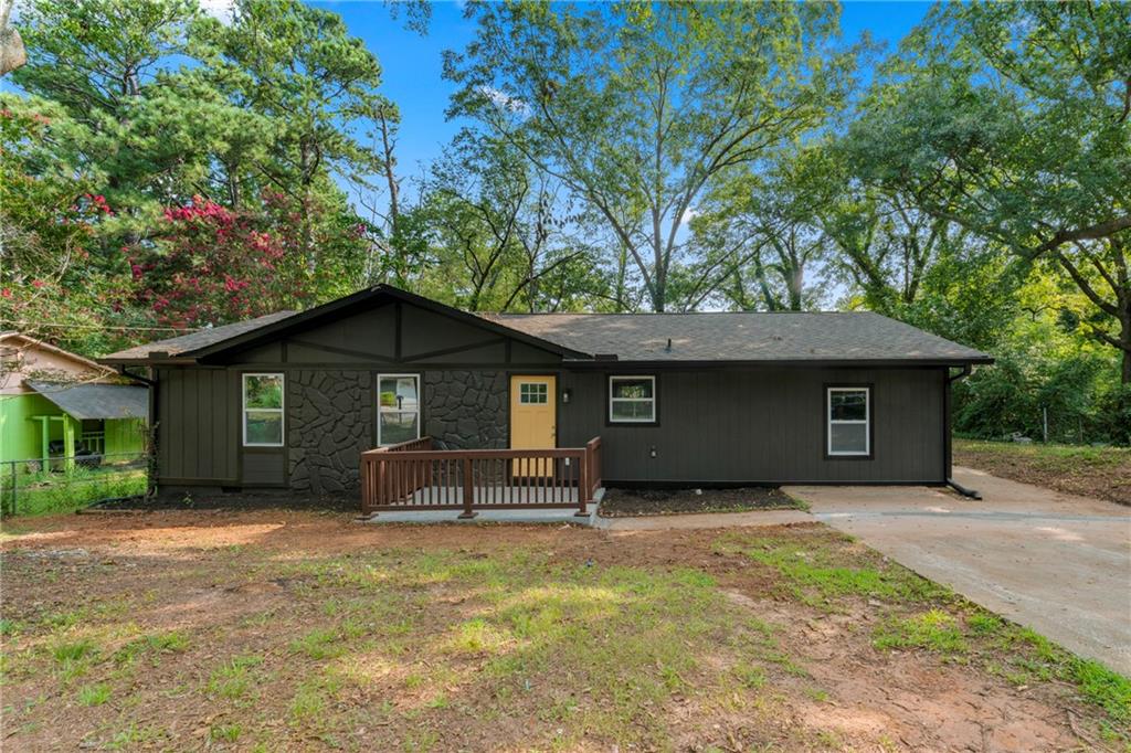1726 West Austin Road Decatur, GA 30032 - Photo 1 of 1 a backyard of a house with large trees and brick wall