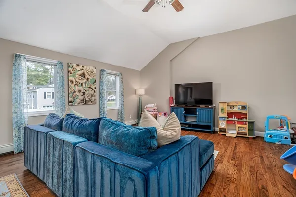 a living room with furniture and a wooden floor