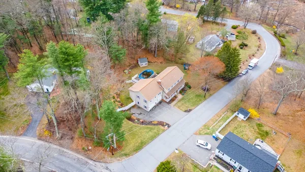 an aerial view of a house with a swimming pool