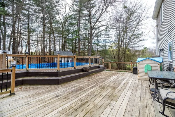 a view of a roof deck with wooden floor and fence