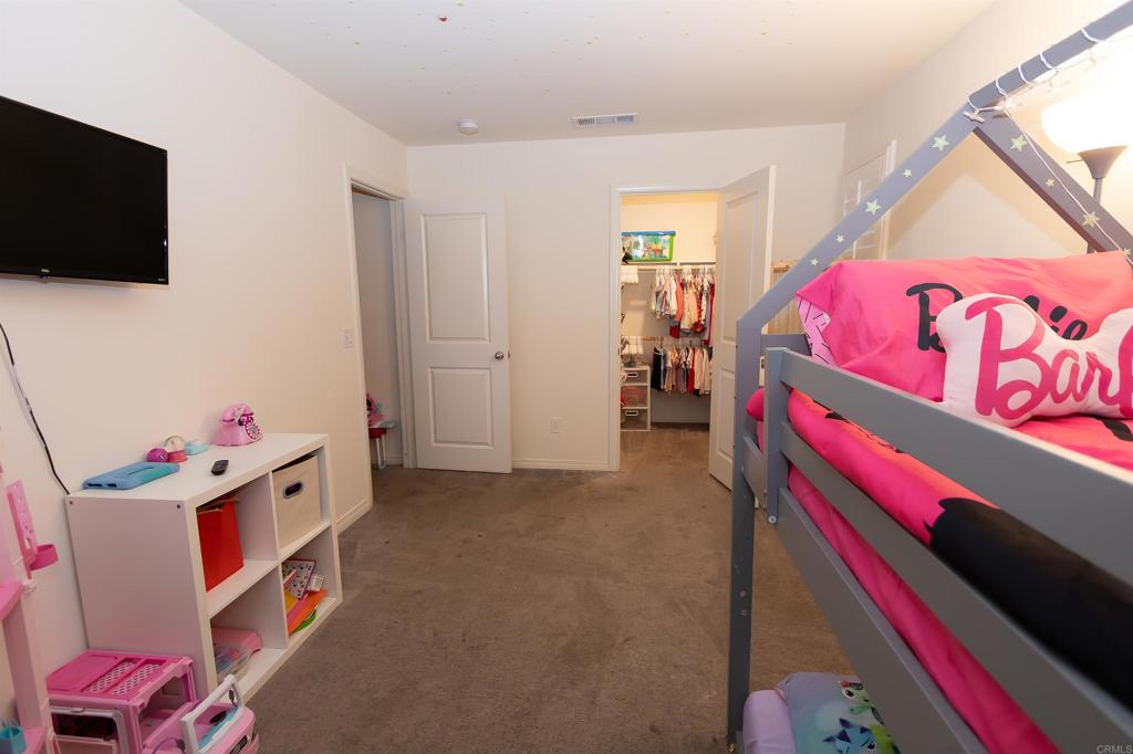 32097 Rambling Court Winchester, CA 92596 - Photo 47 of 62 a bedroom with a bed and a flat screen tv